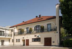 a white building with a red roof at B&B Pod vrbo in Ljubljana