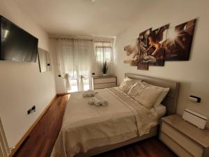 a bedroom with a bed with two stuffed animals on it at RIVA DEL GARDA APART in Riva del Garda