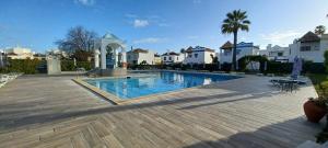 a large swimming pool in a yard with houses at Quinta Velha 22 in Tavira