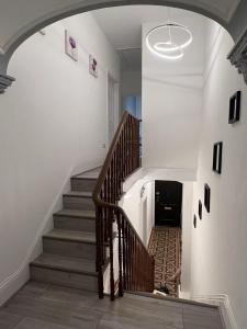 a staircase in a house with a wooden stair case at Heritage Bed & Breakfast in Pembroke Dock