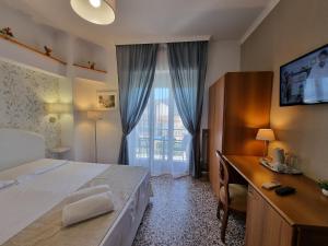 a bedroom with a bed and a dresser and a window at Villa Susy Relais in Sant'Agnello
