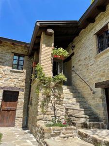 a stone house with stairs leading up to a door at Agriturismo Il Noce d'Oro in Borgo Val di Taro