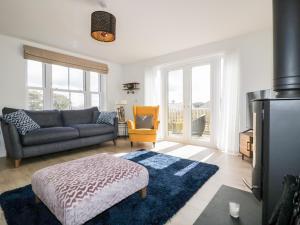 a living room with a couch and a chair at Gwel Nans in St. Agnes