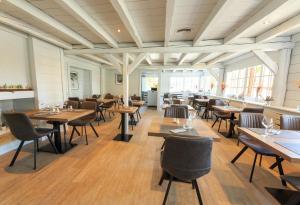 a dining room with wooden tables and chairs at Logis hôtel Annecy nord / Argonay in Argonay