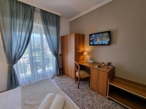 a hotel room with a desk and a window at Villa Susy Relais in Sant'Agnello