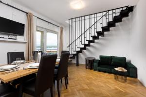 a dining room with a table and a staircase at Apartment Daisy in Vantačići