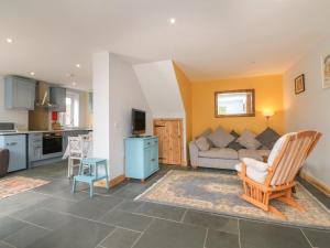 a living room with a couch and a table at Hill Coach House in Watchet