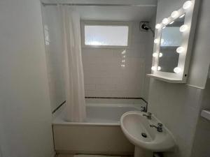 a bathroom with a tub and a sink and a toilet at Impeccable 2-Bed Apartment in Grays London in Grays Thurrock