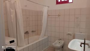 a bathroom with a tub and a toilet and a sink at Elea House in Keramoti +12 photos