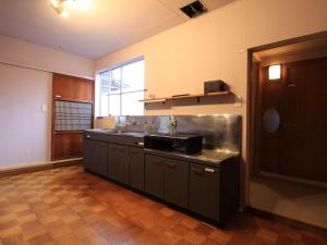 A kitchen or kitchenette at carafuru Japanese Old House