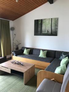a living room with a couch and a coffee table at Ferienhaus Starenweg 8 in Tennenbronn
