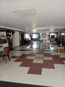 a large room with a lobby with a checkered floor at Hotel Geetanjali Buddha Resort By WB Inn in Bodh Gaya