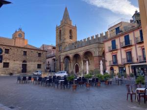 a group of tables and chairs in front of a building at B&B Tulip Lotus Castelbuono in Castelbuono