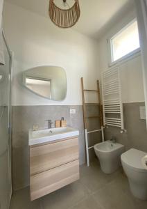 a bathroom with a sink and a toilet and a mirror at Teresa Madre in Procida +20 photos