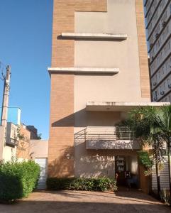 a building with a balcony on the side of it at Novo Grande Hotel in Ribeirão Preto