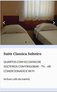 a picture of a bedroom with two beds and avertisement at Novo Grande Hotel in Ribeirão Preto
