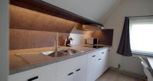 a kitchen with a sink and a counter top at Berkies in Steenokkerzeel