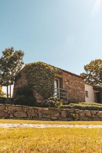 un edificio in mattoni con finestra e muro di pietra di Moinho d'Antoninha a Leomil