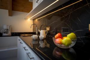 a bowl of fruit on a counter in a kitchen at Apartments Lasteis in La Villa +67 photos