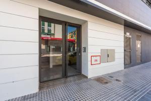 The facade or entrance of Modern apartment next to train/bus station
