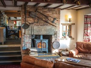 a living room with a brick fireplace with a stove at The Blackamoor Inn in Ripon