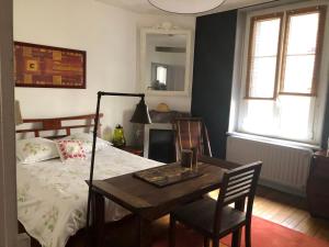 a bedroom with a bed and a table and chairs at Le Campus Victoria I - Train Station & Isabey St - 70m2 in Nancy