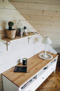 a table with a lamp on it in a room at "Gaujmale" sauna house in nature in Laukbeitini