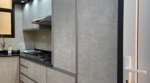 a kitchen with a stove and a counter top at Al Jabal Resort villa 1 in Salalah