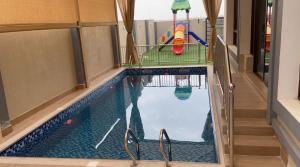 an indoor swimming pool with a pool at Al Jabal Resort villa 1 in Salalah