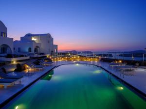 a large swimming pool with lights in a resort at Kalestesia Suites in Akrotiri