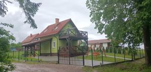 a green house with a playground in front of it at Zielona Ostoja in Ryn