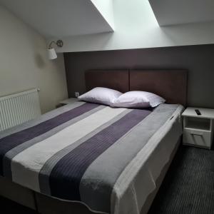 Säng eller sängar i ett rum på Apartament Wileńska
