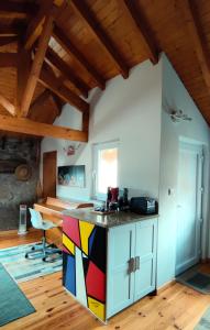 a kitchen with a colorful island in a room at Casa Rural d 'Avó - sossego do campo - 5 adultos in Alhais