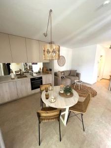 a kitchen and living room with a table and chairs at CUBE S in Medulin