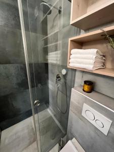 a bathroom with a shower and a toilet and towels at CUBE S in Medulin +93 photos