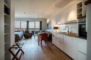 a kitchen and living room with a bed and a table at Weserloft 21 in Bremen
