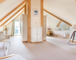a white room with a bedroom and a bed at Ragleighs in Polzeath