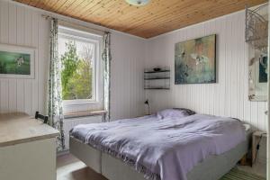 1 dormitorio con cama y ventana en Lovely house in Tranas with a wonderful location by the lake Loren, en Tranås