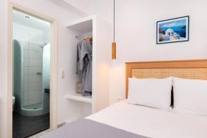 a bedroom with a bed and a walk in shower at Seaside Breeze in Kamari