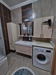 a bathroom with a washing machine and a sink at family villas sapanca in Sapanca +16 photos