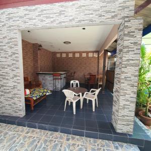 a patio with a table and chairs and a fireplace at Sairee Center Guest House in Koh Tao