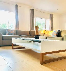 a living room with a couch and a coffee table at Modern Luxury 3 bedroom house in Durban