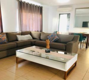 a living room with a couch and a coffee table at Modern Luxury 3 bedroom house in Durban