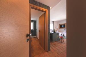 an open door leading to a kitchen with a table at Villa Totò Resort in Cefalù +125 photos