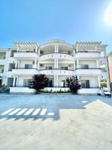 a large building with a parking lot in front of it at Marini Casa in Ulcinj