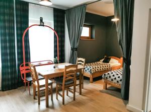 a dining room with a table and chairs and a bedroom at Zakopane Stop in Zakopane