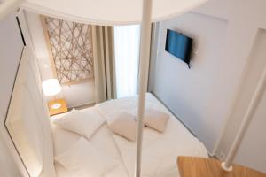 A bed or beds in a room at Dimani Suites