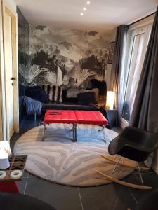 a living room with a red table and a couch at 1+1 in Les Deux Alpes