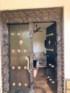 a room with two doors with shells on them at Peters Mansion Bougainvillea Premesis in Mtwapa