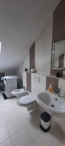 a bathroom with two sinks and a toilet in it at Apartment Illyricum in Bol
